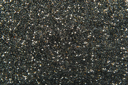 pile of tiny mottled black chia seeds.